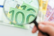 Banknotes and magnifying glass