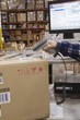 Man scanning bar code in distribution warehouse