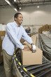 Cheerful man working in distribution warehouse