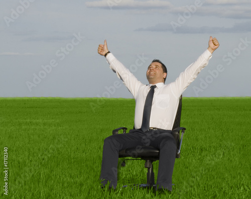 Photo: businessman take energy from nature in the meadow with dark blue businessman take energy from nature in the meadow with dark blue