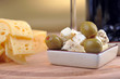 sliced yellow cheese an olives