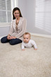 Photo: Mother with six month old baby at home Mother with six month old baby at home