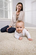 Photo: Mother with baby learning to crawl Mother with baby learning to crawl