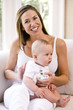 Photo: Mother burping six month old baby after a meal Mother burping six month old baby after a meal