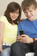 Foto: Teenage Couple Reading Text Message Teenage Couple Reading Text Message