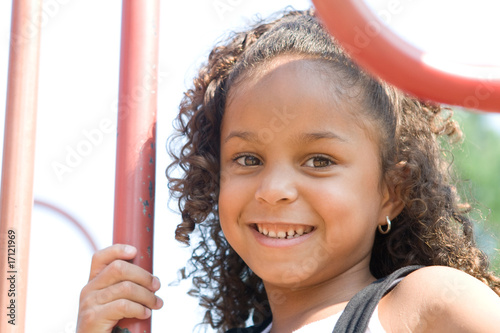 Photo: A beautiful mixed race child enjoying the playground A beautiful mixed race child enjoying the playground