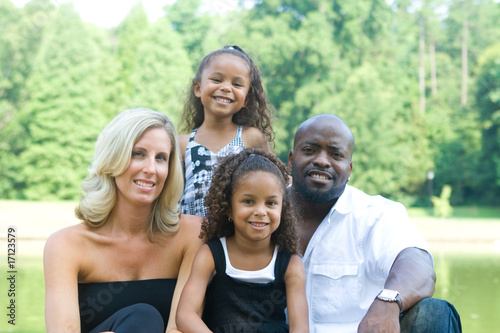 Photo: A loving mixed race family enjoying the park A loving mixed race family enjoying the park