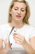 Blond woman cleaning eyeglasses