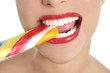 Colorful Lollypop in perfect woman teeth Colorful Lollypop in perfect woman teeth