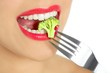 Broccoli on steel fork in woman mouth Broccoli on steel fork in woman mouth
