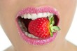 Delicious strawberry fruit in woman mouth Delicious strawberry fruit in woman mouth
