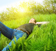 Photo: young man relax in spring grass young man relax in spring grass