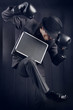 Businessman in boxing gloves with metal suitcase fallen asleep i