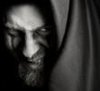 Evil sinister man with malefic wicked grin