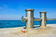 Stainless steel bitts on blue sea background Stainless steel bitts on blue sea background