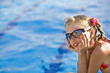 Child girl in red bikini and glasses near blue swimming pool. Child girl in red bikini and glasses near blue swimming pool.