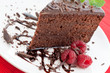 Slice of delicious chocolate cake with fresh raspberries