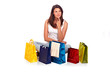 Beautiful woman sitting with bags and thinking