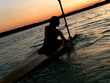Photo: kayaker against sunset kayaker against sunset