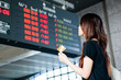 Girl looking at the timetable in a station