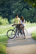 A young couple standing with bicycles holding a map