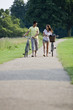 A young couple pushing bicycles