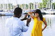 Woman posing for picture near boats