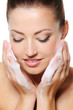 woman washing her face woman washing her face