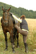 Photo: A woman and a horse. A woman and a horse.