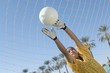Girl Reaching for Soccer Ball