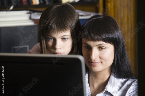 Photo: Mother and daughter looking at computer screen Mother and daughter looking at computer screen