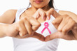 Photo: Heart framing on woman chest with pink badge to support breast c Heart framing on woman chest with pink badge to support breast c