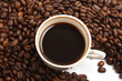Cup of coffee with coffee beans on white background Cup of coffee with coffee beans on white background