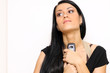 Closeup portrait of a funny woman with a phone standing indoors