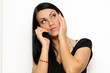 Closeup portrait of a funny woman with a phone standing indoors