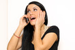 Closeup portrait of a funny woman with a phone standing indoors