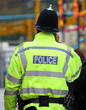 A Police Officer Using his Mobile Phone.