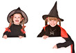 Child girl in Halloween witch costume with banner.