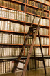 Shelves old books library and wooden stepladder on the floor