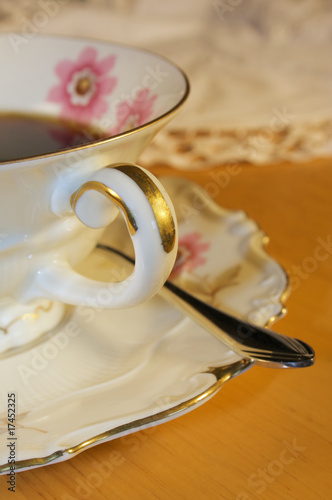 Photo: Old fashioned porcelain coffee set on a desk. Old fashioned porcelain coffee set on a desk.