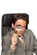 Young businessman with a magnifying glass Young businessman with a magnifying glass