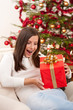 Surprised woman with Christmas gift
