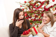 Two women unpacking Christmas present