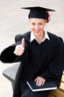 Photo: Female graduate with thumb up Female graduate with thumb up