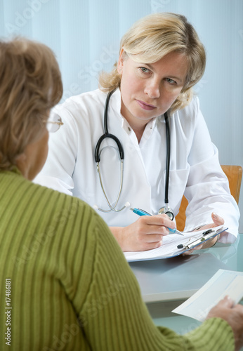 Photo: doctor explaining diagnosis to his female patient doctor explaining diagnosis to his female patient