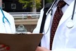 Doctor nurse outdoors discuss chart