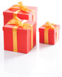 Various sizes red gift boxes with gold ribbon.