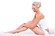 Caucasian woman stroking her beauty legs