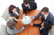 High Angle of business people holding a globe. Global business High Angle of business people holding a globe. Global business