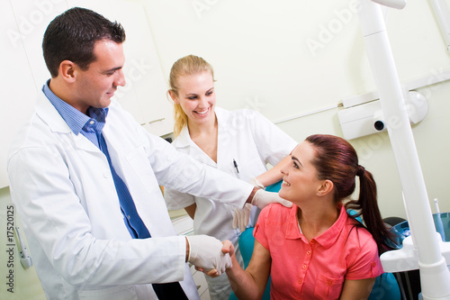 Photo: dentist congralating patient for successful operation dentist congralating patient for successful operation